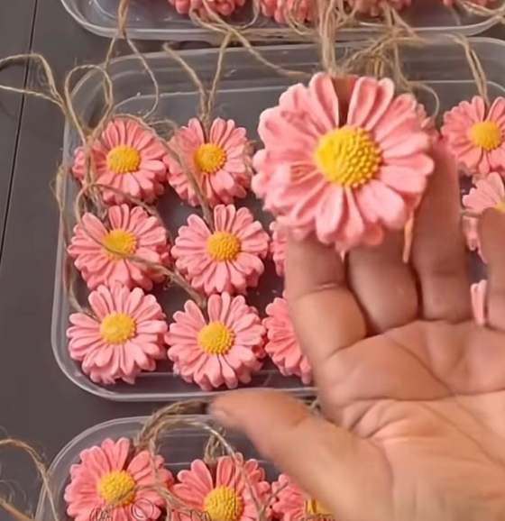 Pink daisy-shaped glycerin soaps tied with jute